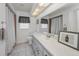 Bright bathroom featuring a large mirror and shower/tub combo for everyday convenience at 395 Forest Park Rd, Oldsmar, FL 34677