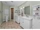 Well-lit bathroom with double vanity, ample storage, and shower offers convenience and style at 395 Forest Park Rd, Oldsmar, FL 34677