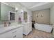 Bright bathroom features dual vanities and a soaking tub for a relaxing at-home spa experience at 395 Forest Park Rd, Oldsmar, FL 34677