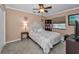 Comfortable bedroom provides a relaxing retreat with soft carpet and a ceiling fan at 395 Forest Park Rd, Oldsmar, FL 34677