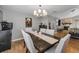 Dining room with chandelier adjacent to the living room featuring a stone fireplace at 395 Forest Park Rd, Oldsmar, FL 34677