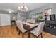 Inviting dining room with elegant chandelier, six chairs, and wine storage at 395 Forest Park Rd, Oldsmar, FL 34677