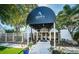 Welcoming entrance to Ardea Country Club with a covered walkway, landscaped beds, and mature trees at 395 Forest Park Rd, Oldsmar, FL 34677