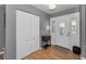 Bright foyer featuring a decorative front door, laminate wood floors, and a closet at 395 Forest Park Rd, Oldsmar, FL 34677