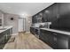 Modern kitchen featuring stainless steel appliances and dark cabinetry at 395 Forest Park Rd, Oldsmar, FL 34677