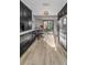 Kitchen with stainless steel fridge and dining table in view of a screened-in patio at 395 Forest Park Rd, Oldsmar, FL 34677