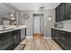 A contemporary kitchen featuring black cabinets, stainless appliances, and an open design to the living area at 395 Forest Park Rd, Oldsmar, FL 34677