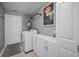 Functional laundry room with washer, dryer, and ample storage solutions for easy organization at 395 Forest Park Rd, Oldsmar, FL 34677
