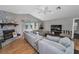 Bright living room featuring stone fireplace, ceiling fan, and ample seating at 395 Forest Park Rd, Oldsmar, FL 34677