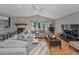 Comfortable living room with stone fireplace, ceiling fan, and large sectional couch at 395 Forest Park Rd, Oldsmar, FL 34677