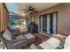 Covered patio area with comfortable seating and outdoor grill, perfect for entertaining by the pool at 395 Forest Park Rd, Oldsmar, FL 34677