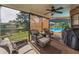 Relaxing screened-in patio with views of the pool and water provides a peaceful outdoor escape at 395 Forest Park Rd, Oldsmar, FL 34677