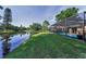 View of the screened-in pool overlooking the water and greenery at 395 Forest Park Rd, Oldsmar, FL 34677