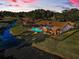 Aerial view of a screened pool in backyard surrounded by a dark metal fence at 395 Forest Park Rd, Oldsmar, FL 34677