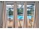 View of the pool area through sliding glass doors, offering seamless indoor-outdoor living at 395 Forest Park Rd, Oldsmar, FL 34677