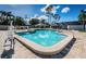 Inviting swimming pool with chair lift, complemented by lounge seating and lush greenery in background at 395 Forest Park Rd, Oldsmar, FL 34677