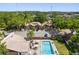 Overhead shot of complex with pool, surrounded by trees and residential buildings at 4013 Muriel Pl, Tampa, FL 33614
