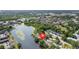Aerial view of the property, situated on a tranquil lake surrounded by lush greenery at 4013 Muriel Pl, Tampa, FL 33614