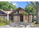 Charming home featuring a unique architectural design and a well-maintained front yard with mature trees at 4013 Muriel Pl, Tampa, FL 33614