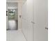 Hallway with storage closets and a view into the living room with a water view at 4013 Muriel Pl, Tampa, FL 33614