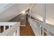 Hallway on the second floor with wood floors and decorative white railings at 4013 Muriel Pl, Tampa, FL 33614