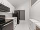 Well-equipped kitchen with white cabinets, black appliances, and ample counter space at 4013 Muriel Pl, Tampa, FL 33614