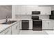Updated kitchen features white cabinetry, stainless steel appliances and granite countertops at 4013 Muriel Pl, Tampa, FL 33614