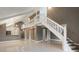 Open living space with staircase, modern lighting, and glossy tile flooring at 4013 Muriel Pl, Tampa, FL 33614