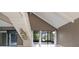 Bright living room featuring a staircase and sliding glass doors that lead to an enclosed porch with a view at 4013 Muriel Pl, Tampa, FL 33614