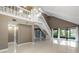 Bright living space featuring a staircase and sliding glass doors that lead to an enclosed porch with a view at 4013 Muriel Pl, Tampa, FL 33614