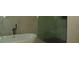 Modern bathroom featuring a freestanding tub, glass-enclosed shower, and light-colored marble wall at 4101 W Mango Ave, Tampa, FL 33616