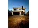 Modern two-story home with dark-trimmed windows and attached garage with unfinished landscaping at dusk at 4101 W Mango Ave, Tampa, FL 33616
