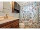 Bathroom featuring a vanity and a toilet, plus a closet and decorative shower curtain at 4204 Northwind Ln, Tampa, FL 33624