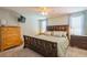 This bedroom features a ceiling fan, carpet, and an accent wall with a flatscreen TV at 4204 Northwind Ln, Tampa, FL 33624