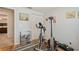 Bright bedroom featuring a fitness center area with an exercise bike and a small book shelf at 4204 Northwind Ln, Tampa, FL 33624