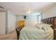 Bright bedroom featuring a ceiling fan, a pair of closets, and an accent wall with a flatscreen TV at 4204 Northwind Ln, Tampa, FL 33624