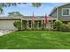 Well-kept front yard with lush lawn and flowering plants adding curb appeal at 4204 Northwind Ln, Tampa, FL 33624