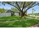 Landscaped front yard with mature tree, green lawn, and inviting curb appeal at 4204 Northwind Ln, Tampa, FL 33624