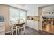 Cozy kitchen nook featuring white cabinets, and a breakfast table bathed in natural light at 4204 Northwind Ln, Tampa, FL 33624