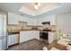 Well-maintained kitchen with stainless steel appliances, white cabinets and functional layout at 4204 Northwind Ln, Tampa, FL 33624