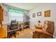 Bright home office space with wood floors, a desk, an accent chair, and built in shelving at 4204 Northwind Ln, Tampa, FL 33624