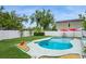 A backyard featuring a kidney shaped pool, well maintained grass and fenced in yard at 4204 Northwind Ln, Tampa, FL 33624