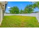 Spacious backyard featuring lush green grass and a pristine white fence, perfect for outdoor activities and relaxation at 4220 Woodlark Dr, Tampa, FL 33624