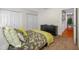 Bedroom with a green accent wall, carpet flooring, neutral bedspread, and a dresser with succulent decor at 4220 Woodlark Dr, Tampa, FL 33624