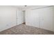 A bright bedroom featuring a large closet with bi-fold doors and neutral carpet at 4220 Woodlark Dr, Tampa, FL 33624