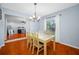 A cozy dining area featuring hardwood floors, bright natural light, and neutral colors at 4220 Woodlark Dr, Tampa, FL 33624