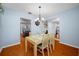 Hardwood floor dining room with views into the kitchen and living areas, creating an inviting and seamless flow at 4220 Woodlark Dr, Tampa, FL 33624