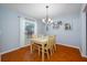 A dining room filled with natural light and wood floors, featuring a contemporary light fixture at 4220 Woodlark Dr, Tampa, FL 33624
