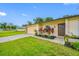 Charming single-story home featuring a well-maintained lawn, attached garage, and inviting front entrance with decorative plants at 4220 Woodlark Dr, Tampa, FL 33624