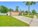Lovely home with an attached garage, a wide driveway, and verdant lawn and landscaping, creating an inviting facade at 4220 Woodlark Dr, Tampa, FL 33624